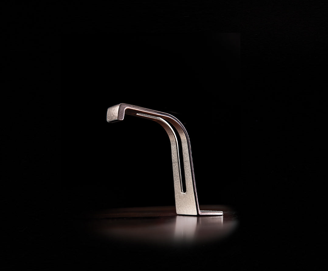 An image of the handwash faucet on a dark background.